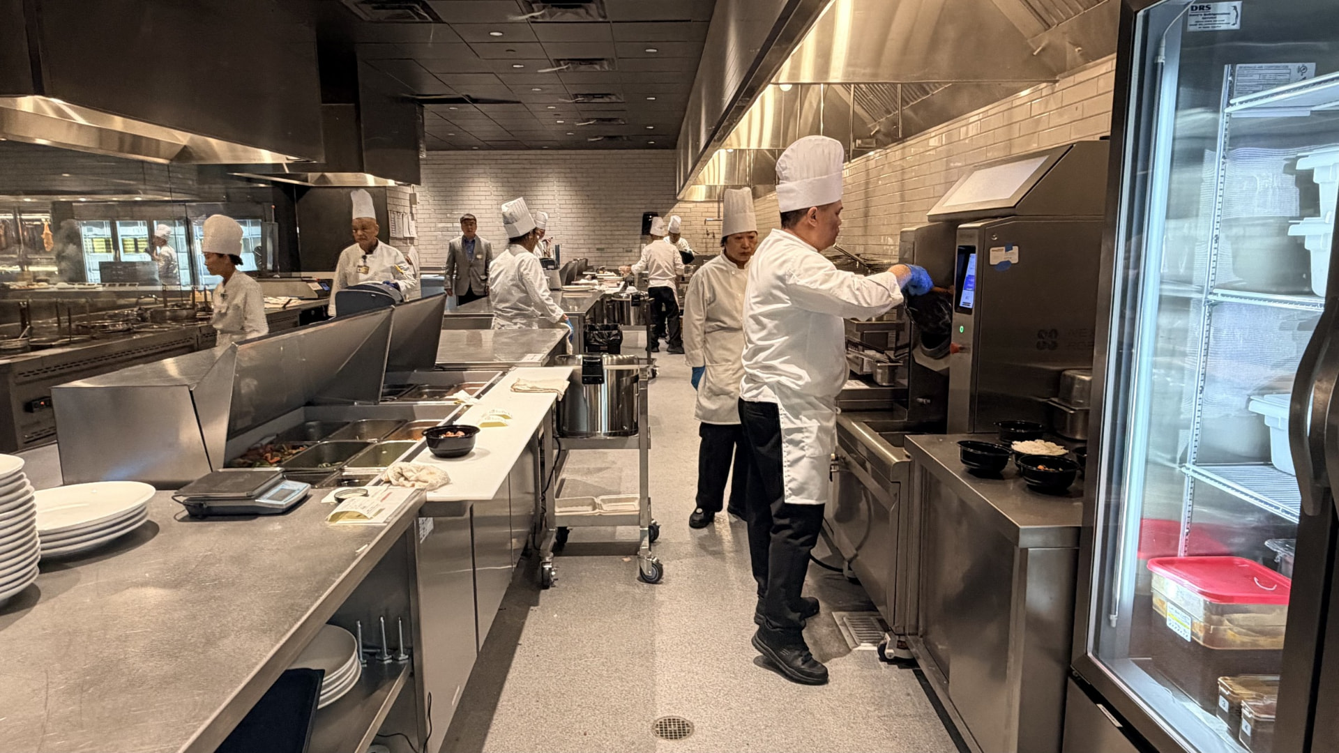 Kitchen staff working with Robby One in a commercial kitchen