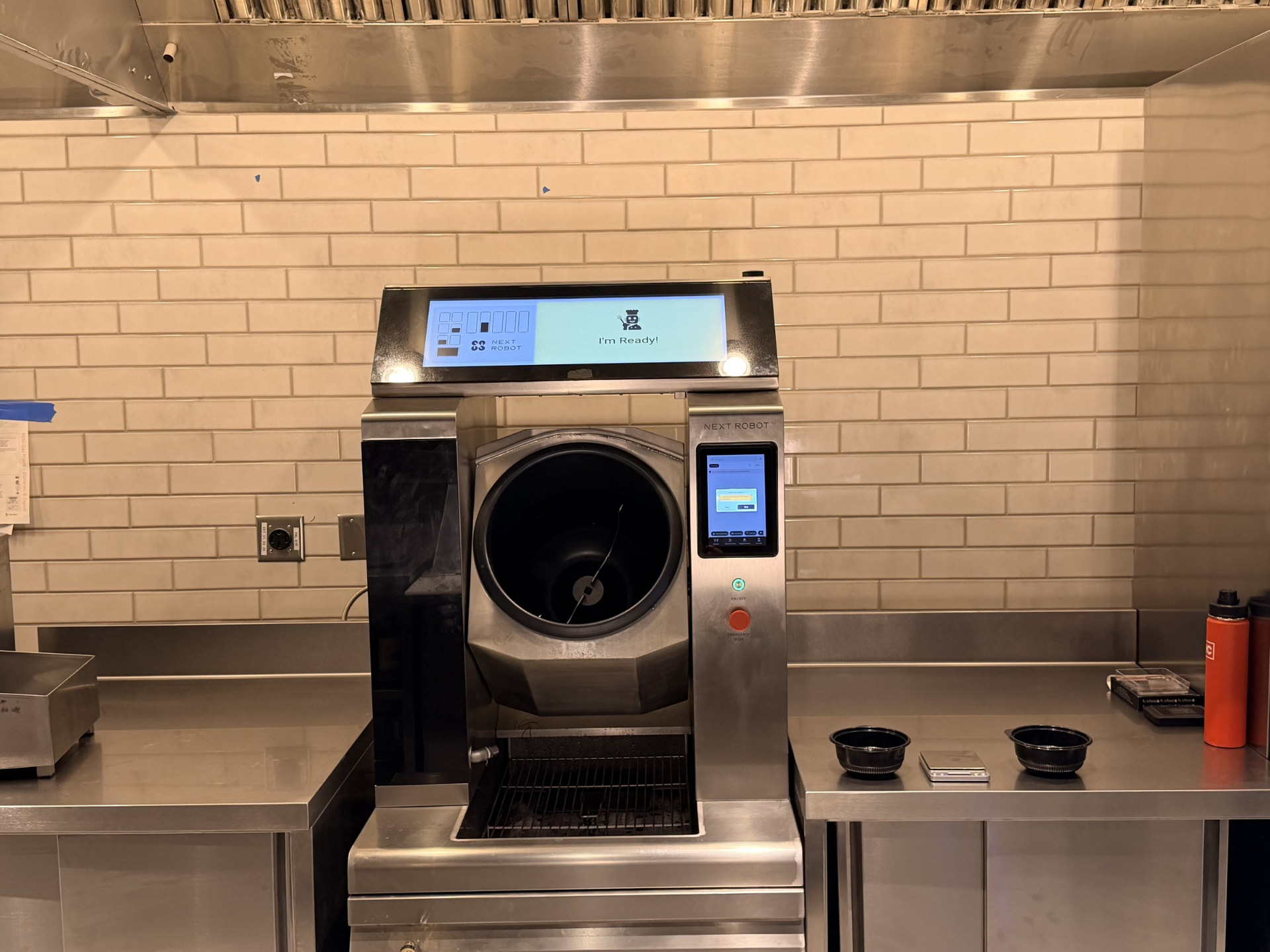 Robby One cooking system installed beneath a commercial kitchen hood