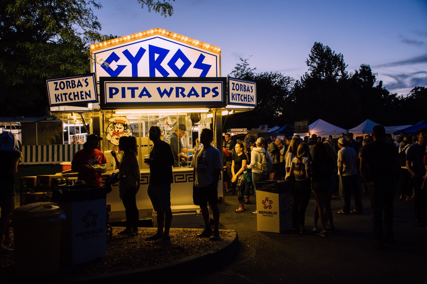 Event visitors queuing at a busy festival food stall
